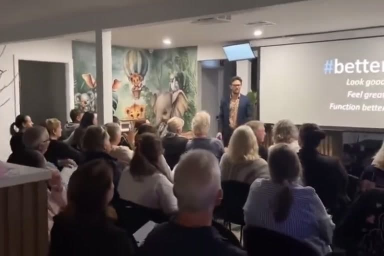 A packed room at a live presentation